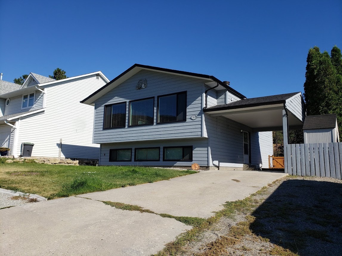 A two-story house with a garage and a driveway.
